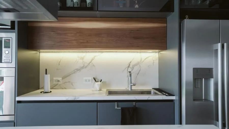 Integrated kitchen appliances hidden behind cabinetry in a Bath home