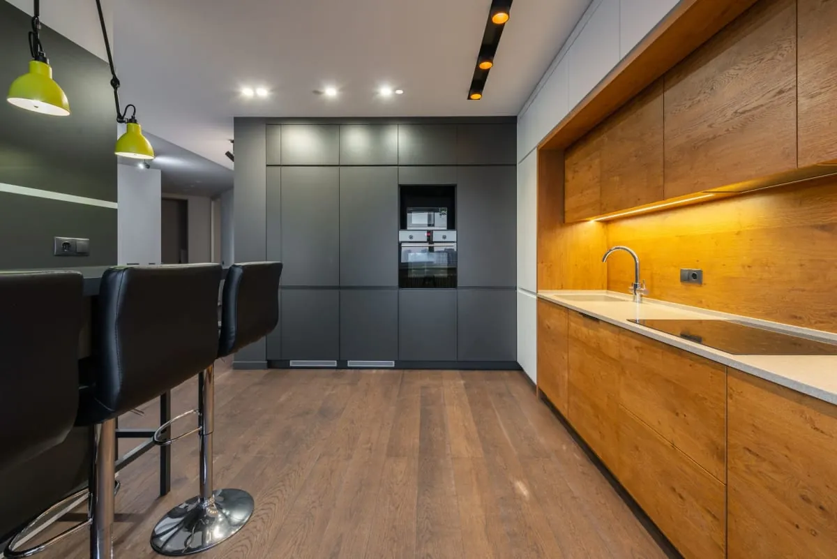 Well-lit modern kitchen with layered lighting in a Bath home