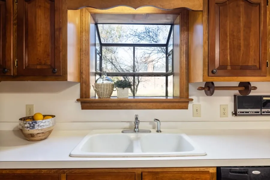 Kitchen sink and tap beneath a window in a Bath home