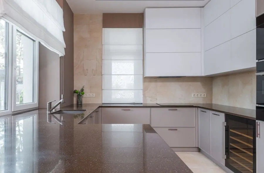 Stone kitchen worktop with undermounted sink being inspected for joint quality