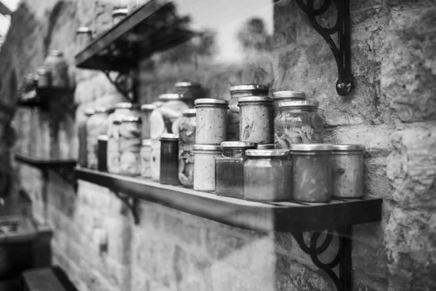 Larder cupboard with open shelves and jars in a Bath kitchen