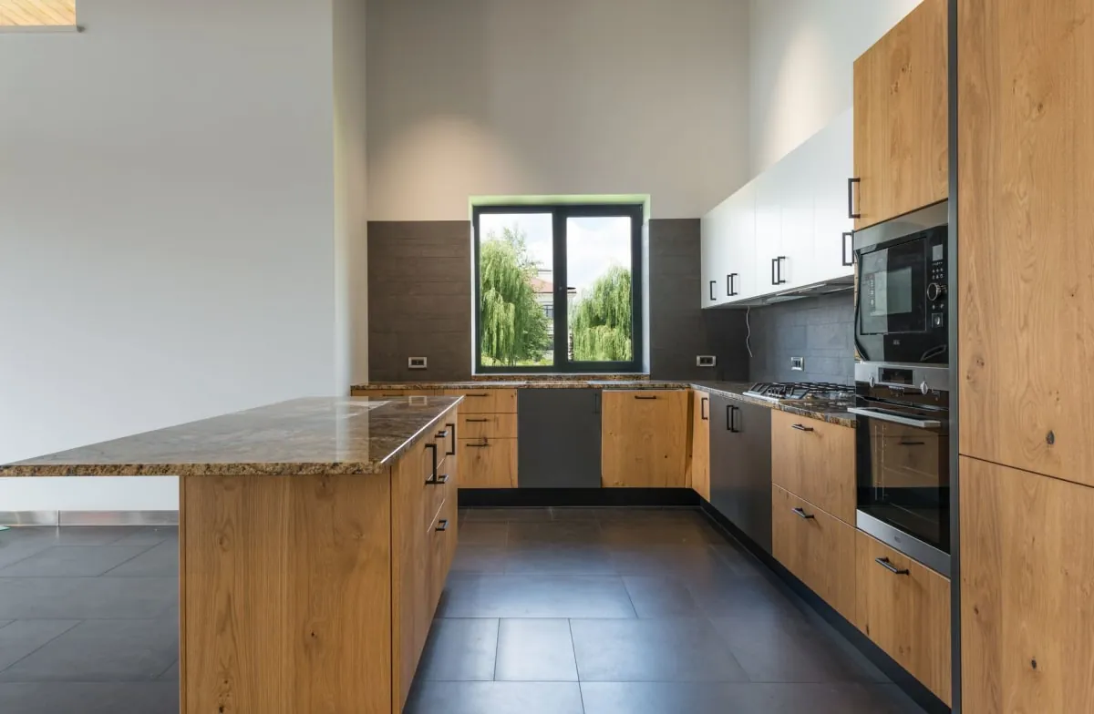 Modern fitted kitchen in a Bath home with cabinets, worktop and island