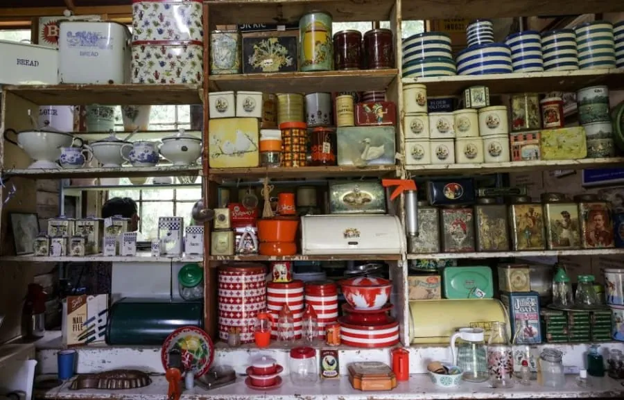 Traditional shelving stacked with tins and storage jars in a period Bath kitchen larder